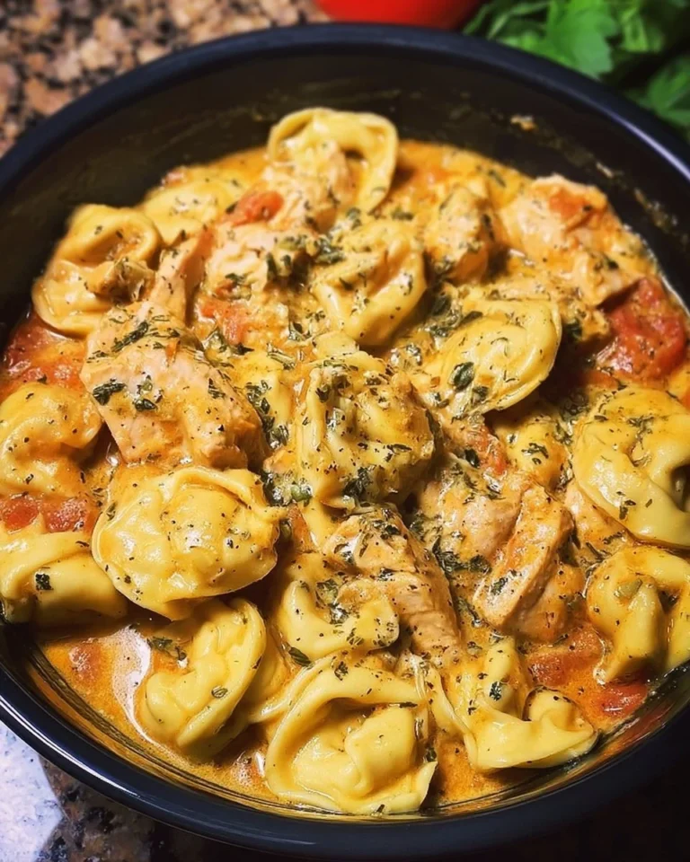 Delicious CrockPot Chicken Tortellini served in a bowl with fresh herbs