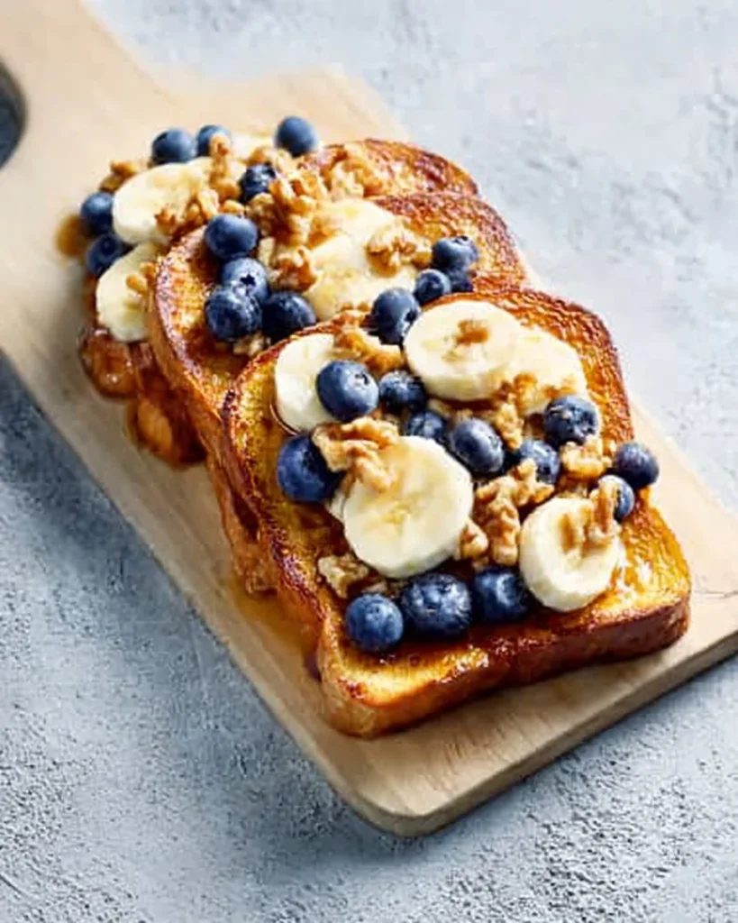 Delicious French Toast topped with bananas, blueberries, and walnuts