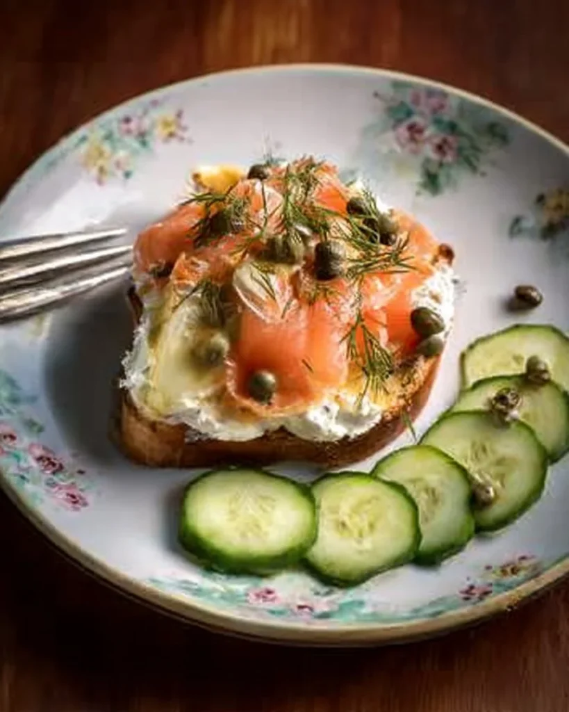 Jacket potatoes with crème fraîche and hot smoked trout garnished on a plate
